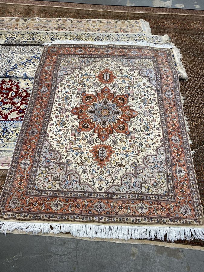 The same ivory rug after shearing, with a rich rust border