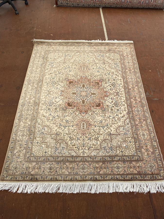 Ivory Heriz-design rug with faded pink border before shearing