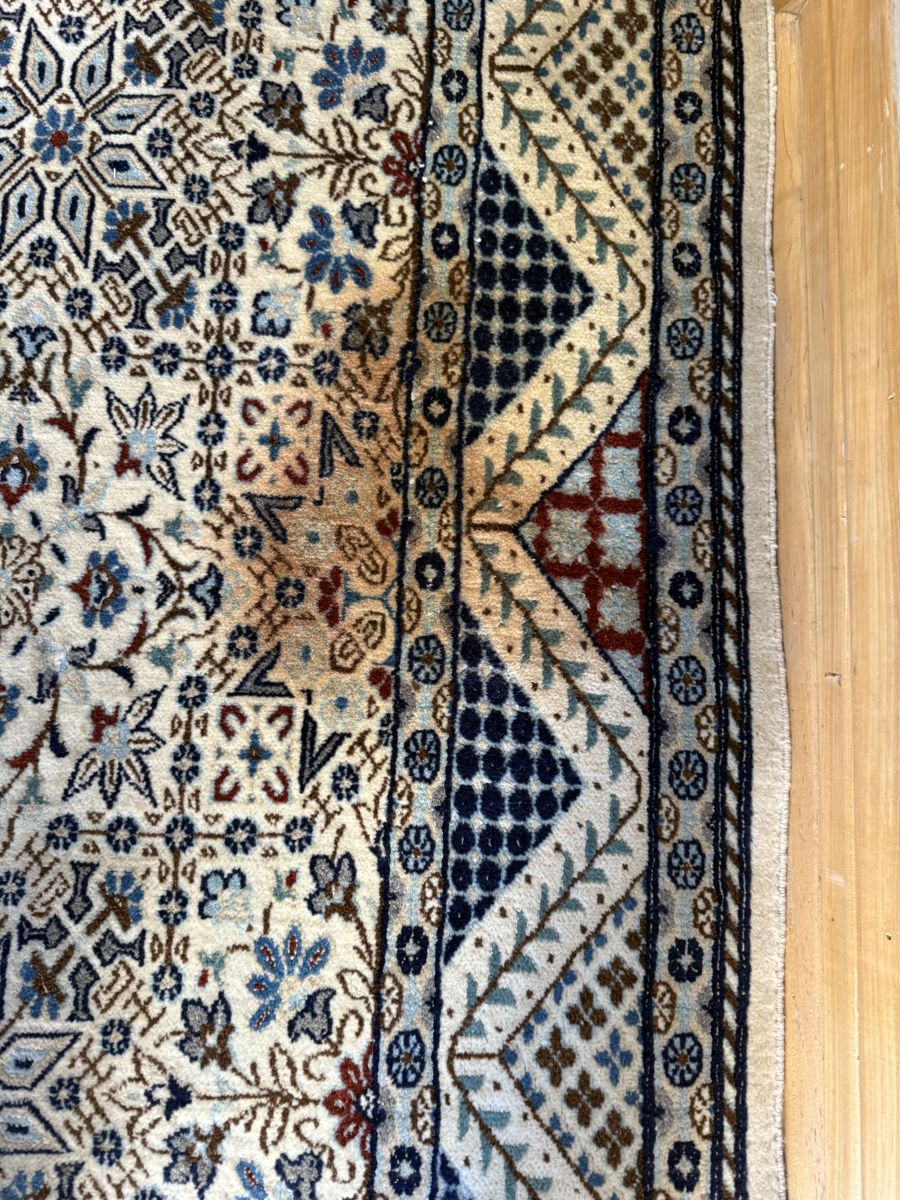 Wool rug with a brown stain before washing